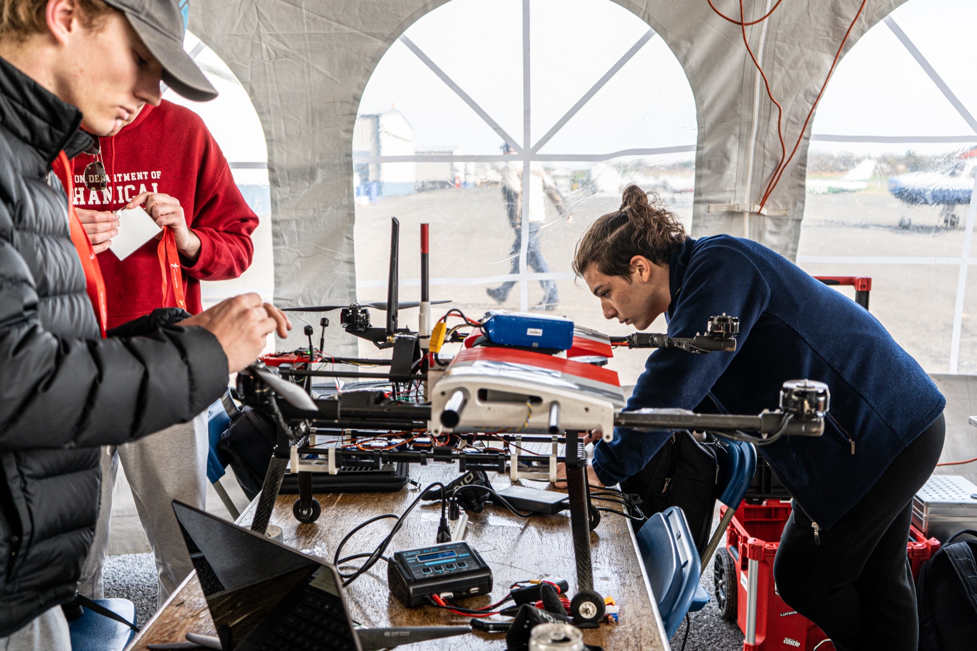 Finn Johnson and a teammate tuning a competition drone on a workbench at the Vertical Flight Society design-and-build competition.