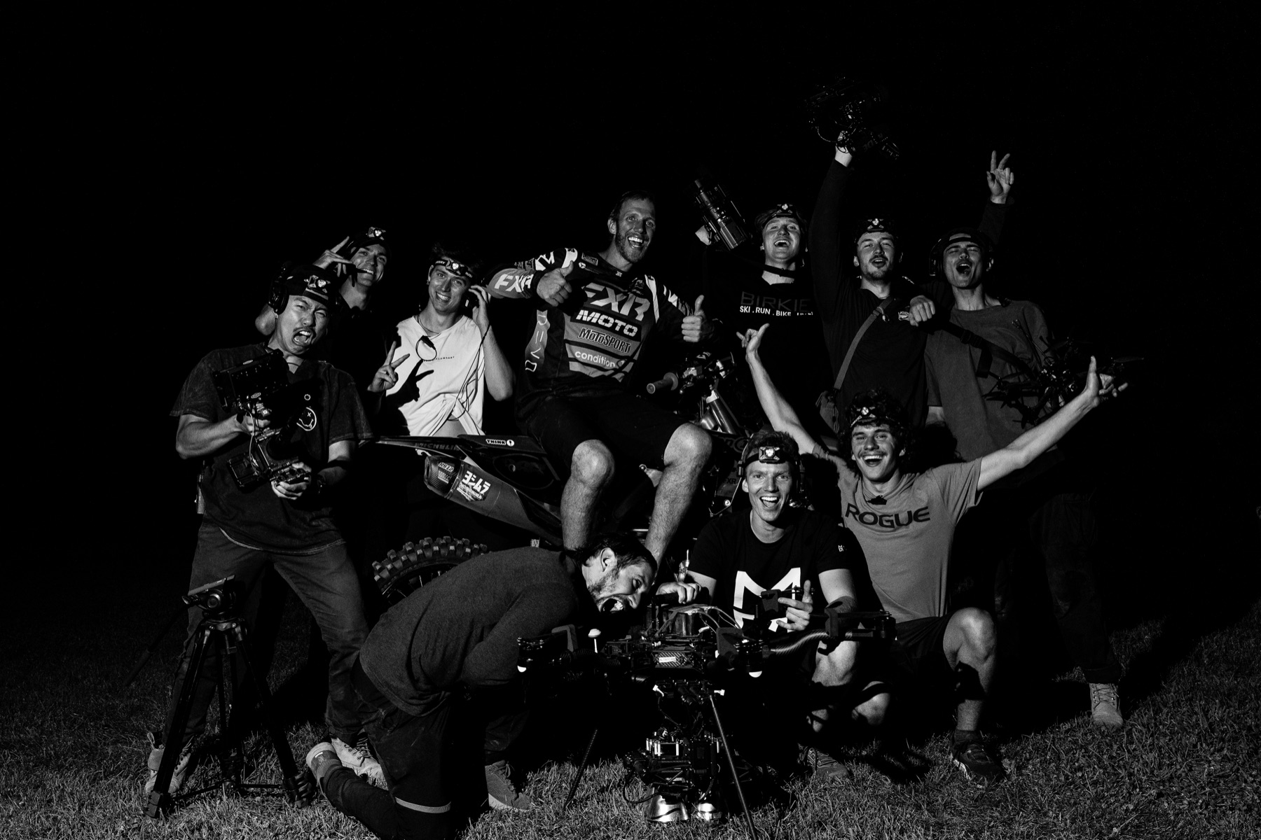 The spec-projects crew gathered around a cinema drone at night after a shoot.
